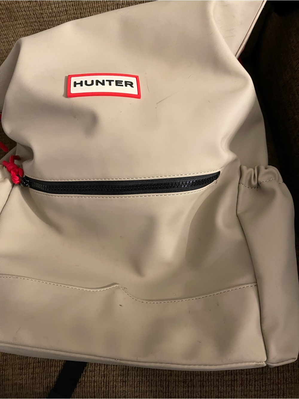 Hunter cream backpack with red logo trim